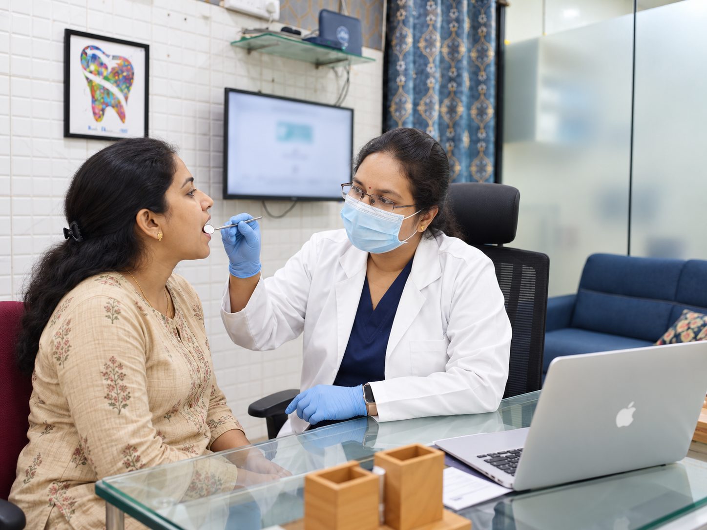 Dr. Divya examining a patient at Yashodhar Dental Clinic